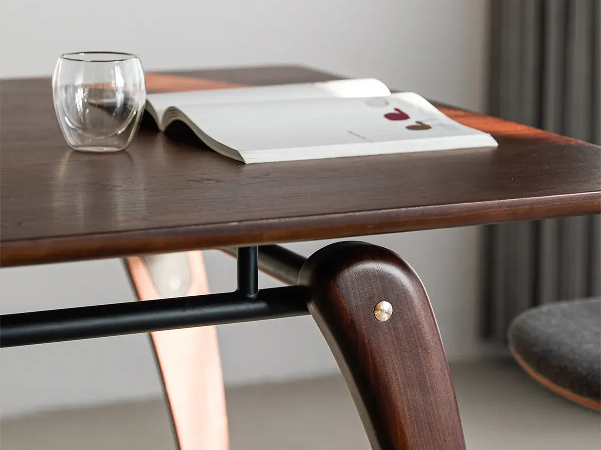 close-up of curved wooden table leg and tabletop edge detail