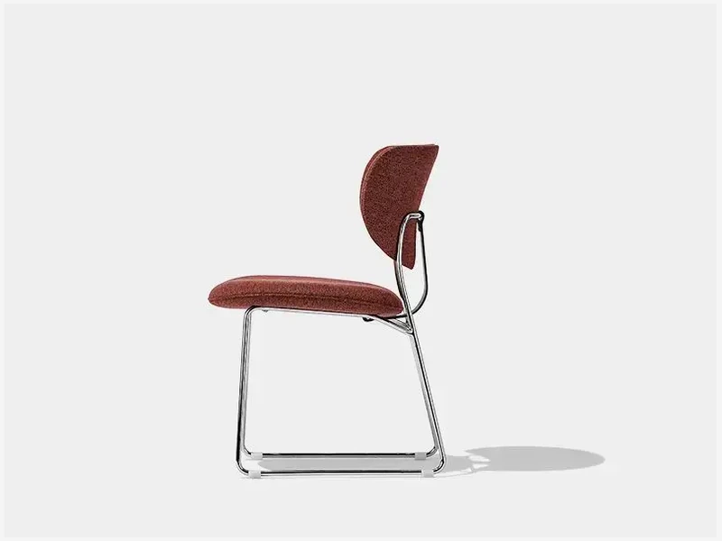 Side view of the CB190 dining chair showing its sled-style steel base