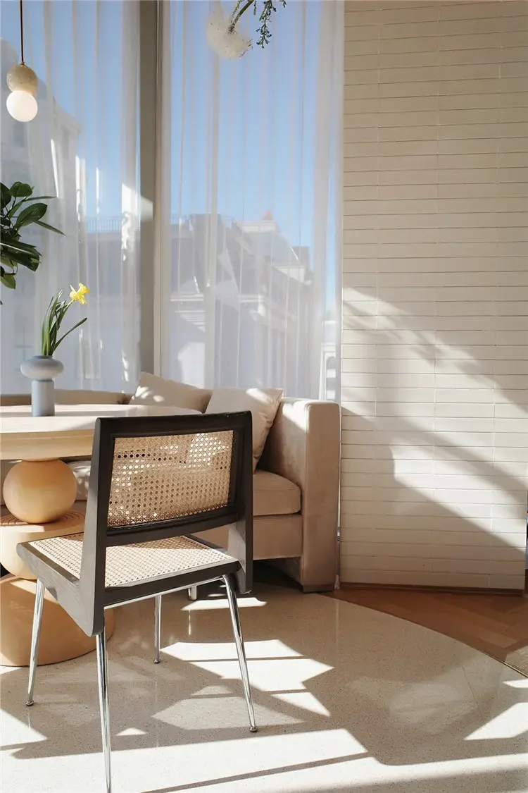 CR215 cane dining chair in an indoor dining setting with a dark wood frame and metal legs
