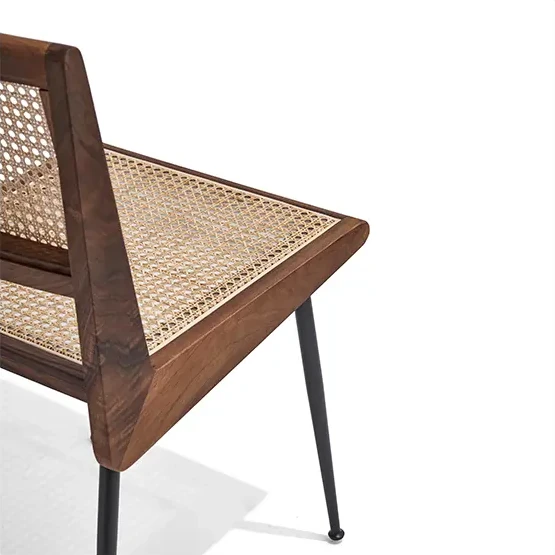 Close-up of the natural cane seat and walnut-tone wooden frame of the CR215 dining chair