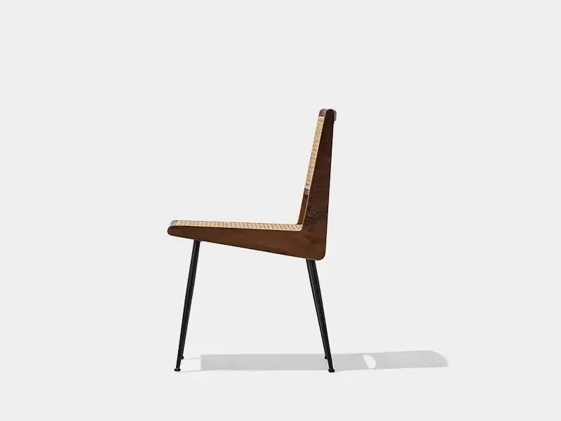 Side view of the CR215 cane dining chair showing its wooden frame and steel legs