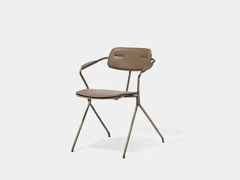 Three-quarter front view of DC-A17 antique brass upholstered arm dining chair