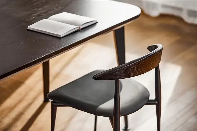 WB316 Black Wood Back Dining Chair WB316 black dining chair beside a dark dining table in an indoor setting