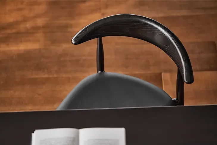 WB316 Black Wood Back Dining Chair WB316 curved black wood backrest positioned at a dining table