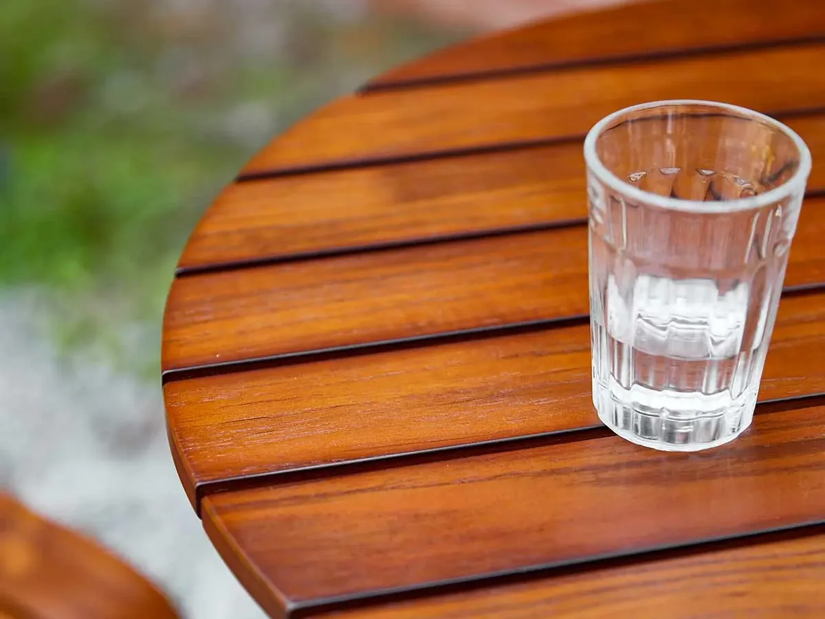 Wood grain and slat spacing on the round tabletop of the YZ-OBT01 bar table